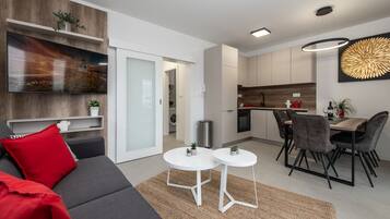 Deluxe Apartment, 2 Bedrooms, Pool Access | Living area | 55-inch Smart TV with satellite channels