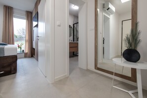 Deluxe Apartment, 1 Bedroom, Pool Access | 1 bedroom, in-room safe, blackout drapes, iron/ironing board