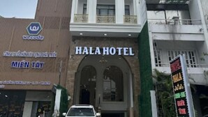 A hotel with a prominent entrance, a sign reading "HALA HOTEL", and a logo above the entrance. - Hala Hotel - by Bay Luxury (Ho Chi Minh City)