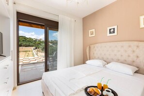 A bedroom with a bed, a breakfast tray, and a view of the outdoors.