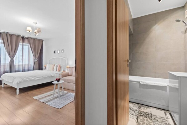 A bedroom with a bed, bedside table, and a nightstand.