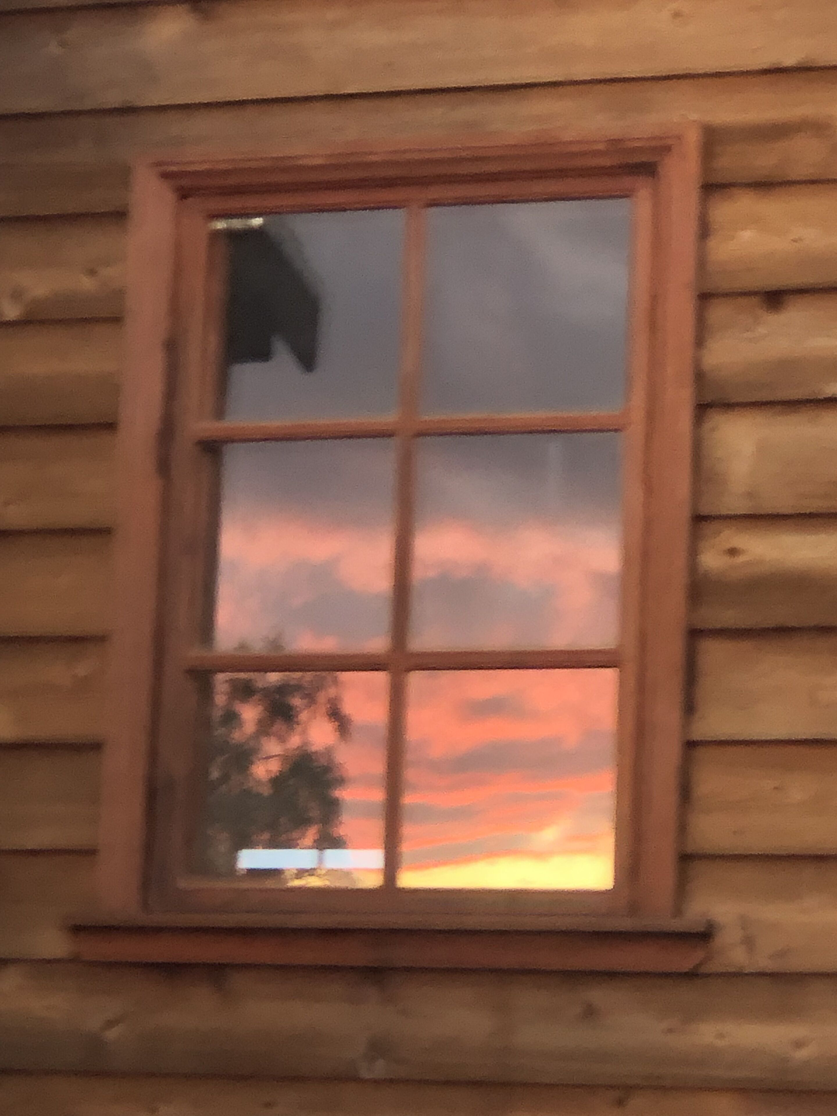 A window with a view of a sunset.