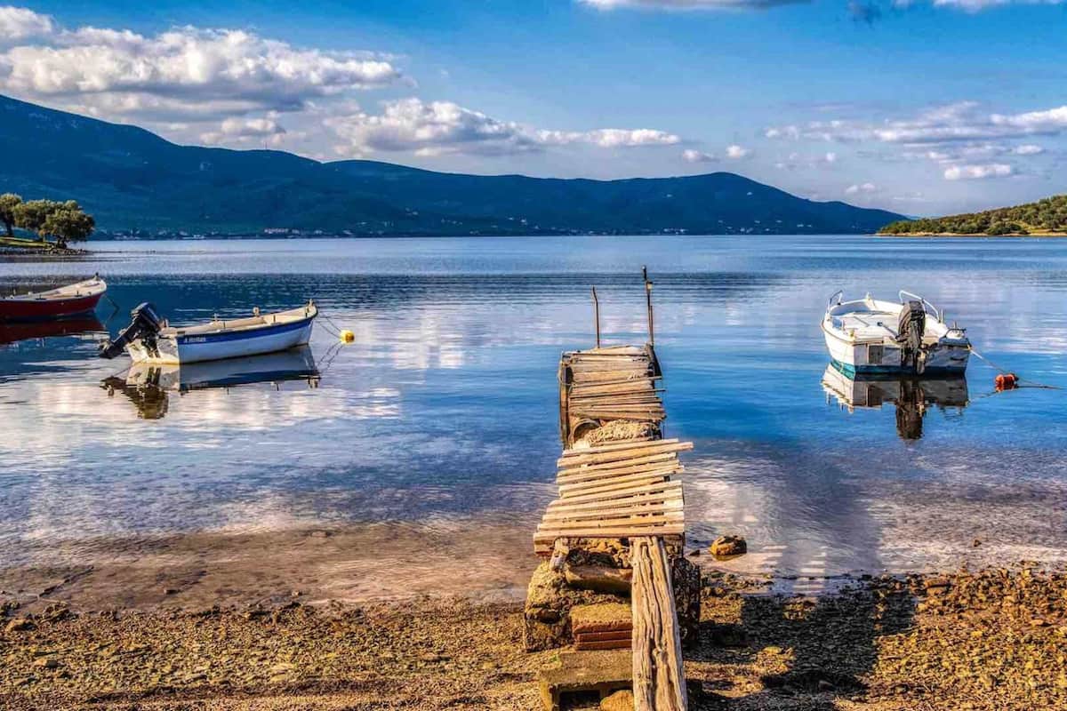 A calm lake with wooden docks and boats.