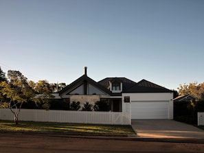 A modern two-story house with a garage, a picket fence, and a clear sky. - Maple Suite, Berry - by Linnaeus Collection (Berry)