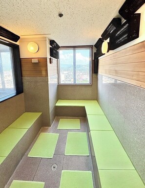 A room with a view of a cityscape, a window, and a bench area. - Yonago Universal Hotel  (Yonago)