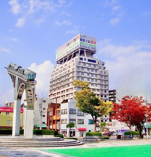 A multi-story building with a prominent sign on top advertising a restaurant. - Yonago Universal Hotel  (Yonago)