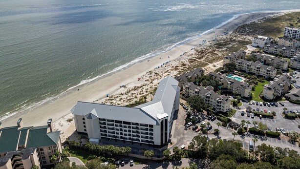 A coastal hotel with a beach view, multiple parking lots, and a large building with a flat roof. - Oceanfront Condo in Wild Dunes! Community Pool! Great View Looking at Ocean! (Isle Of Palms)