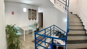 A staircase with a blue handrail leading to an upper floor. - Hostel Jaz (Bucharest)