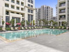 Outdoor pool, a heated pool - Summery 1BR APT in Creek Beach (Dubai)
