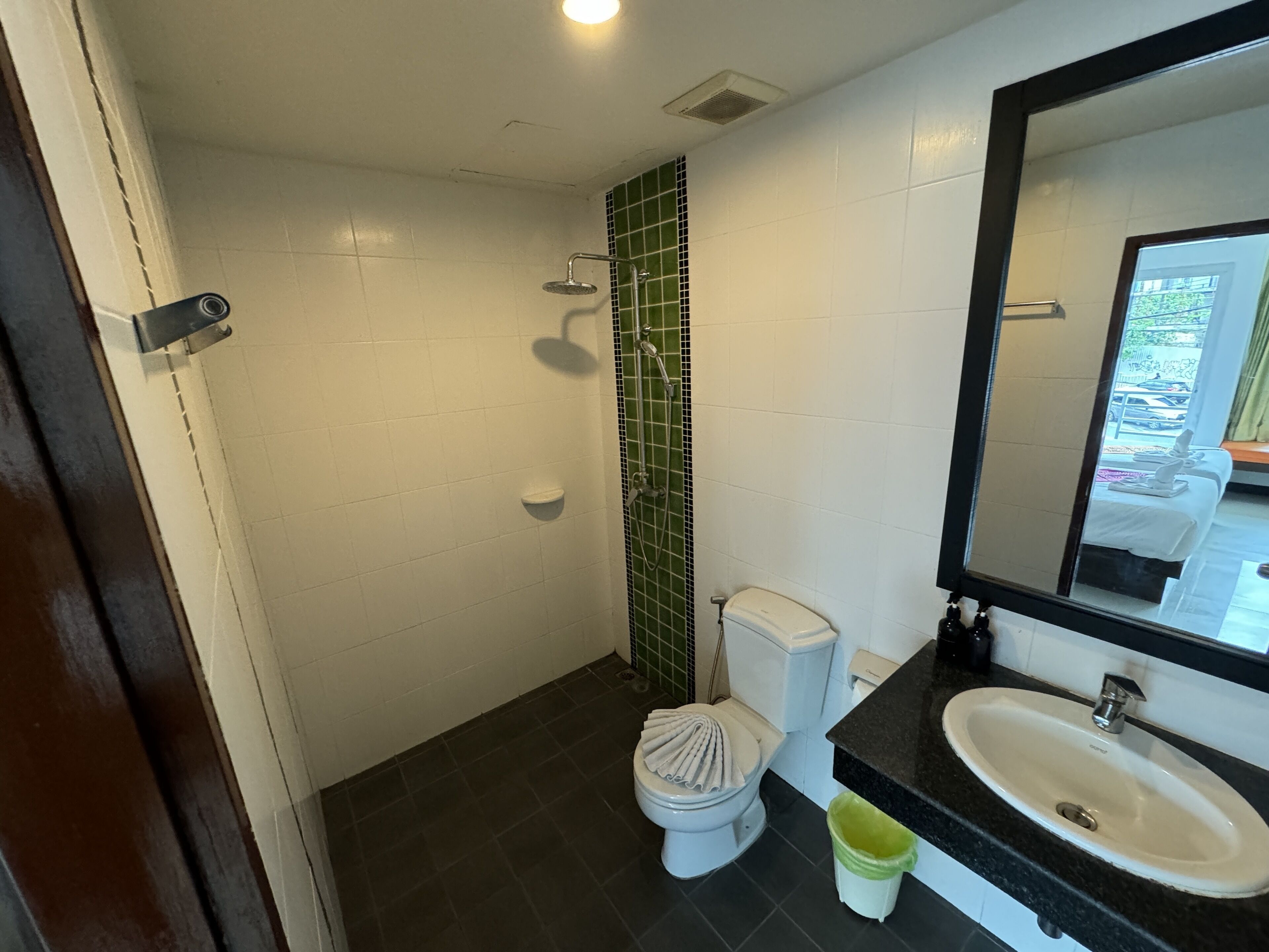 A bathroom with a toilet, sink, and shower.