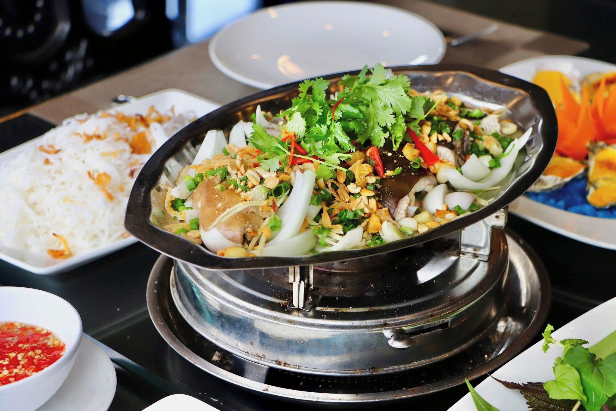 A hot pot meal with various ingredients and a side of white rice.