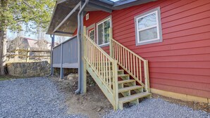 A red house with a wooden staircase leading to a covered porch. - Cozy Cottage w/ Pool Btwn Knoxville & Pigeon Forge (Kodak)