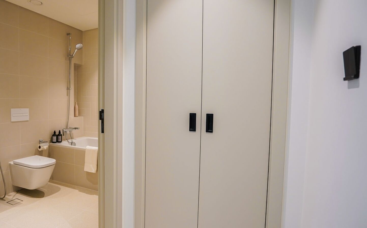 A modern bathroom with a toilet, sink, and shower.