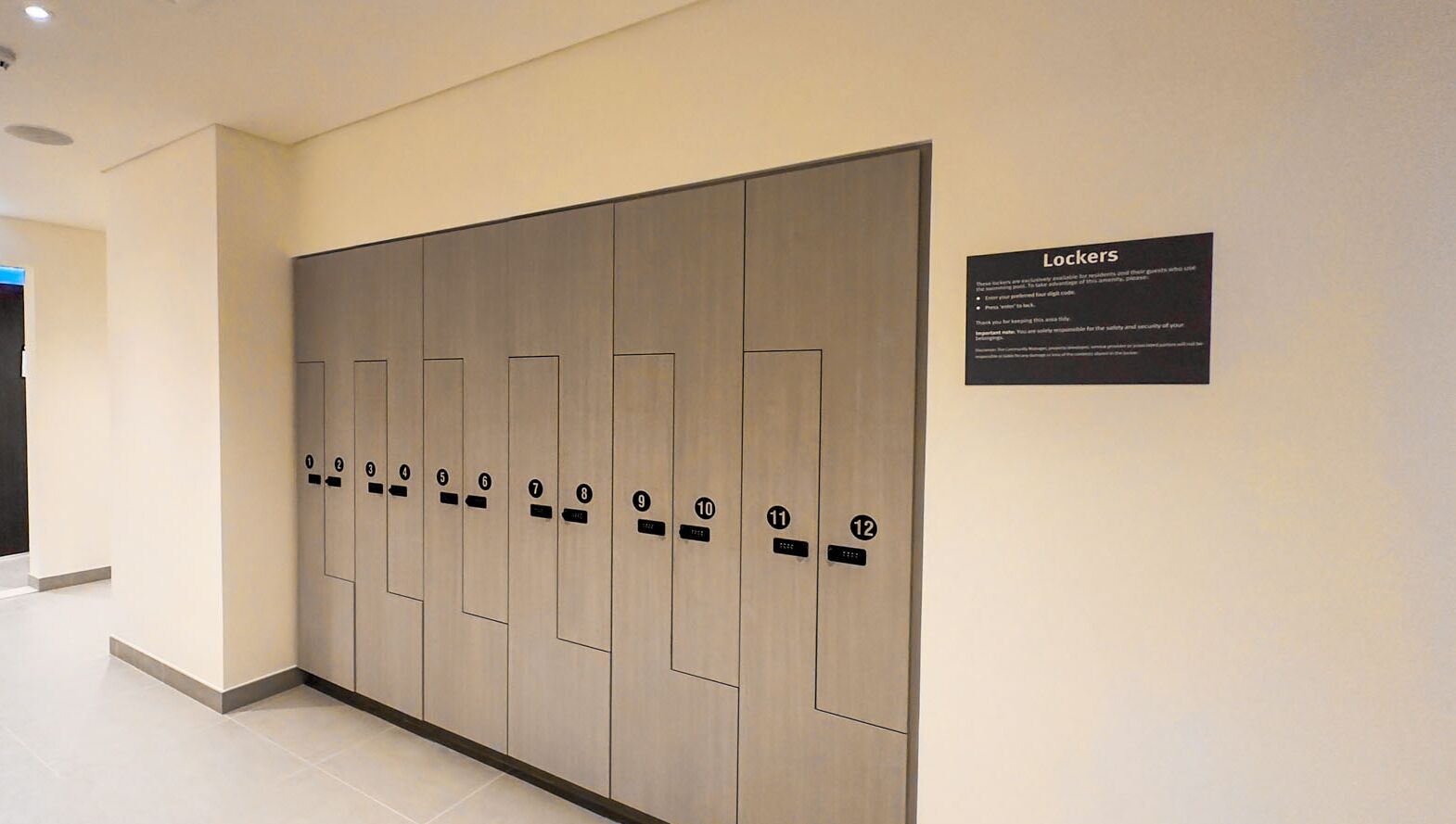 A row of lockers with numbered doors, a sign explaining their use, and a clean, modern interior.