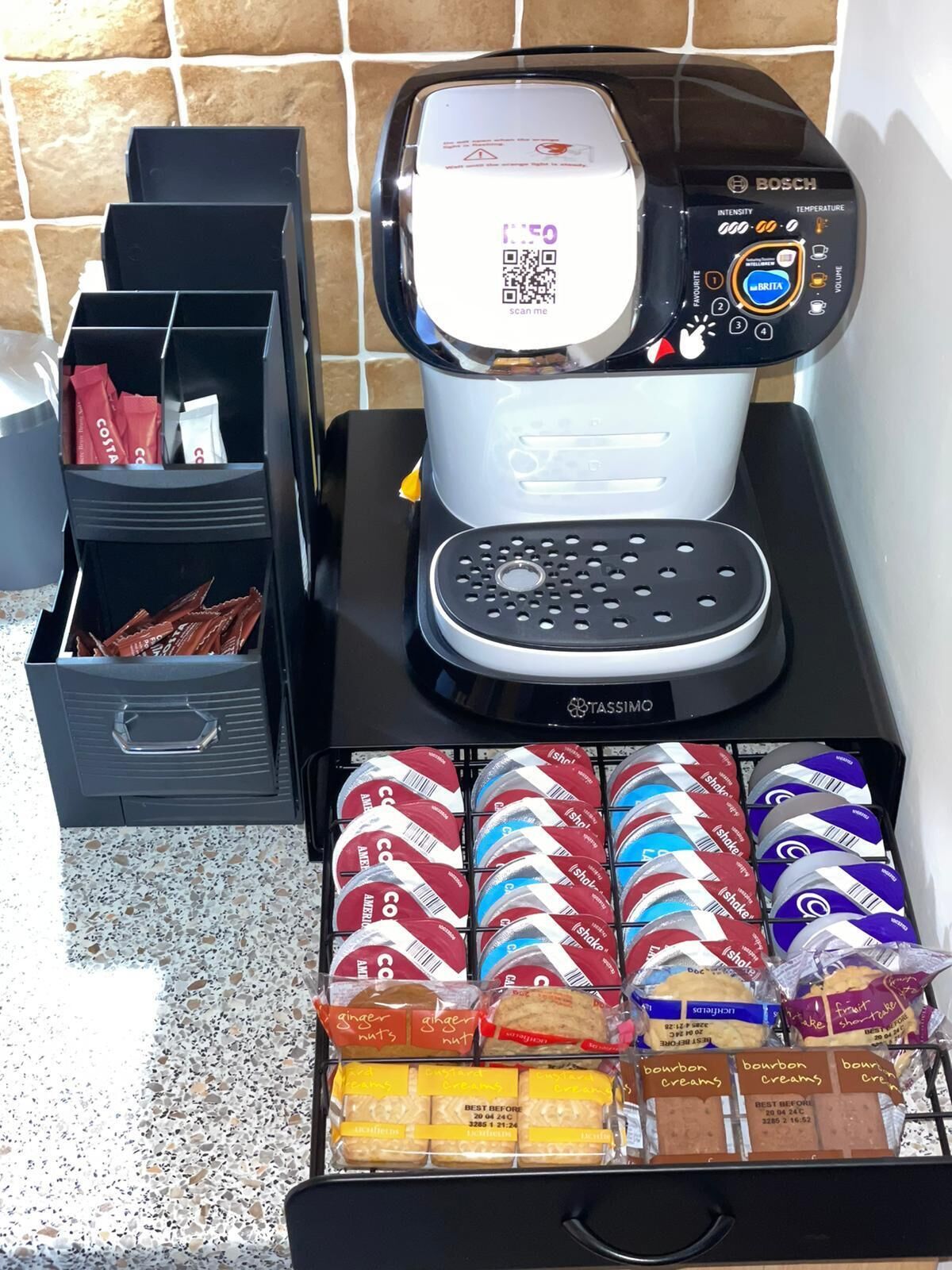 A coffee machine with a digital display and a coffee pod holder.