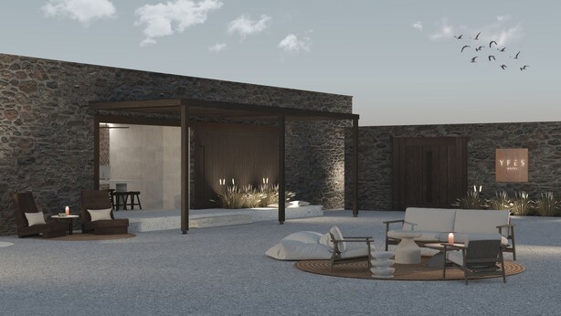 A modern outdoor seating area with stone walls, a covered patio, and a sign for YFES Hotel.