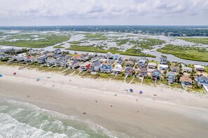 A coastal residential area with houses adjacent to a sandy beach and a marshy landscape. - On Point: Private Pool Across From Beach (Murrells Inlet)