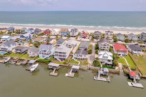 A coastal residential area with houses, a beach, and a marina with boats. - On Point: Private Pool Across From Beach (Murrells Inlet)