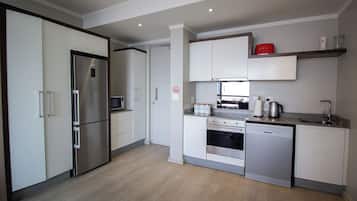 Luxury Apartment | Private kitchen | Full-size fridge, microwave, oven, stovetop