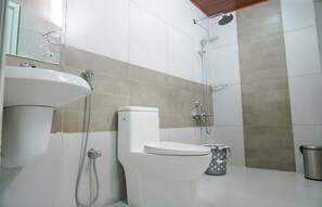 A bathroom with a toilet, sink, and shower. - Misty Bush Munnar - Deluxe Double Room
 (Munnar)