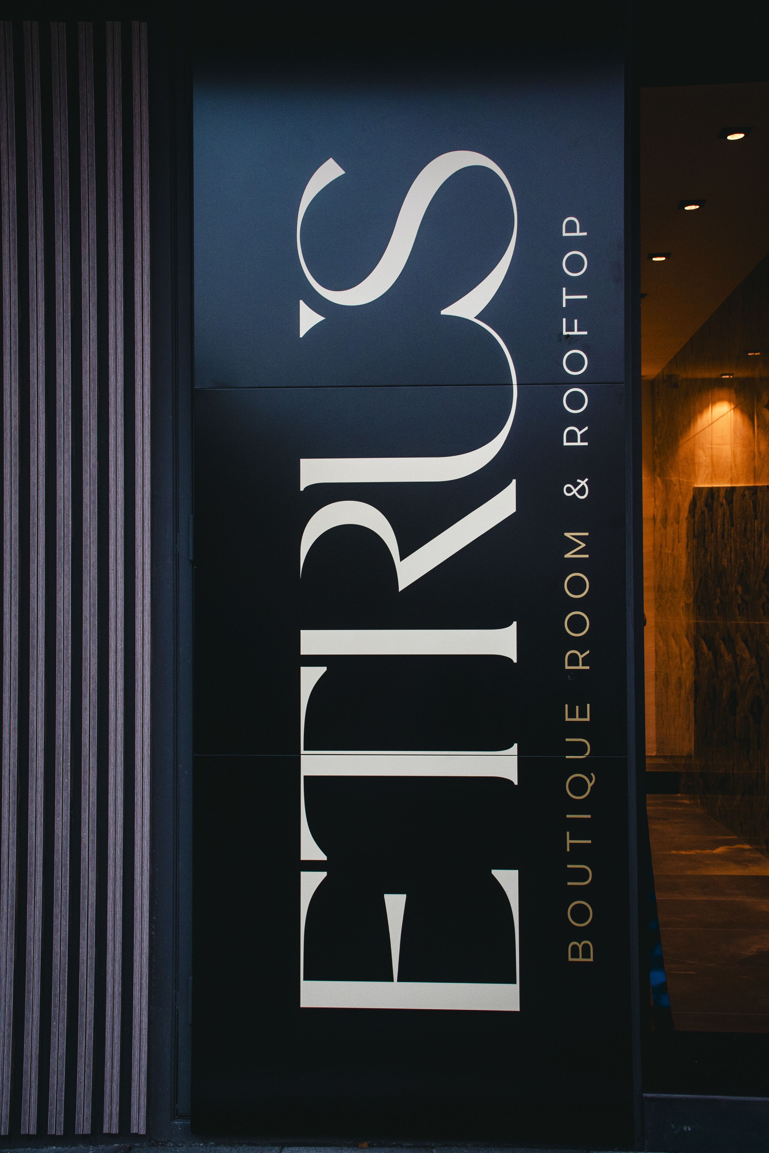 A sign for a boutique room and rooftop.