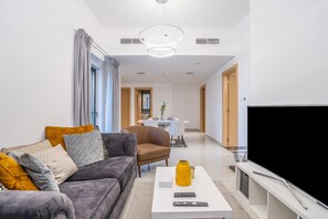 Design Apartment | Living area | 50-inch Smart TV with cable channels, Netflix, streaming services - Tanin - Modern Spacious 1BR Apartment With 2 Balconies (Dubai)