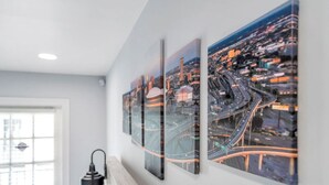 A wall with three framed cityscape photographs.