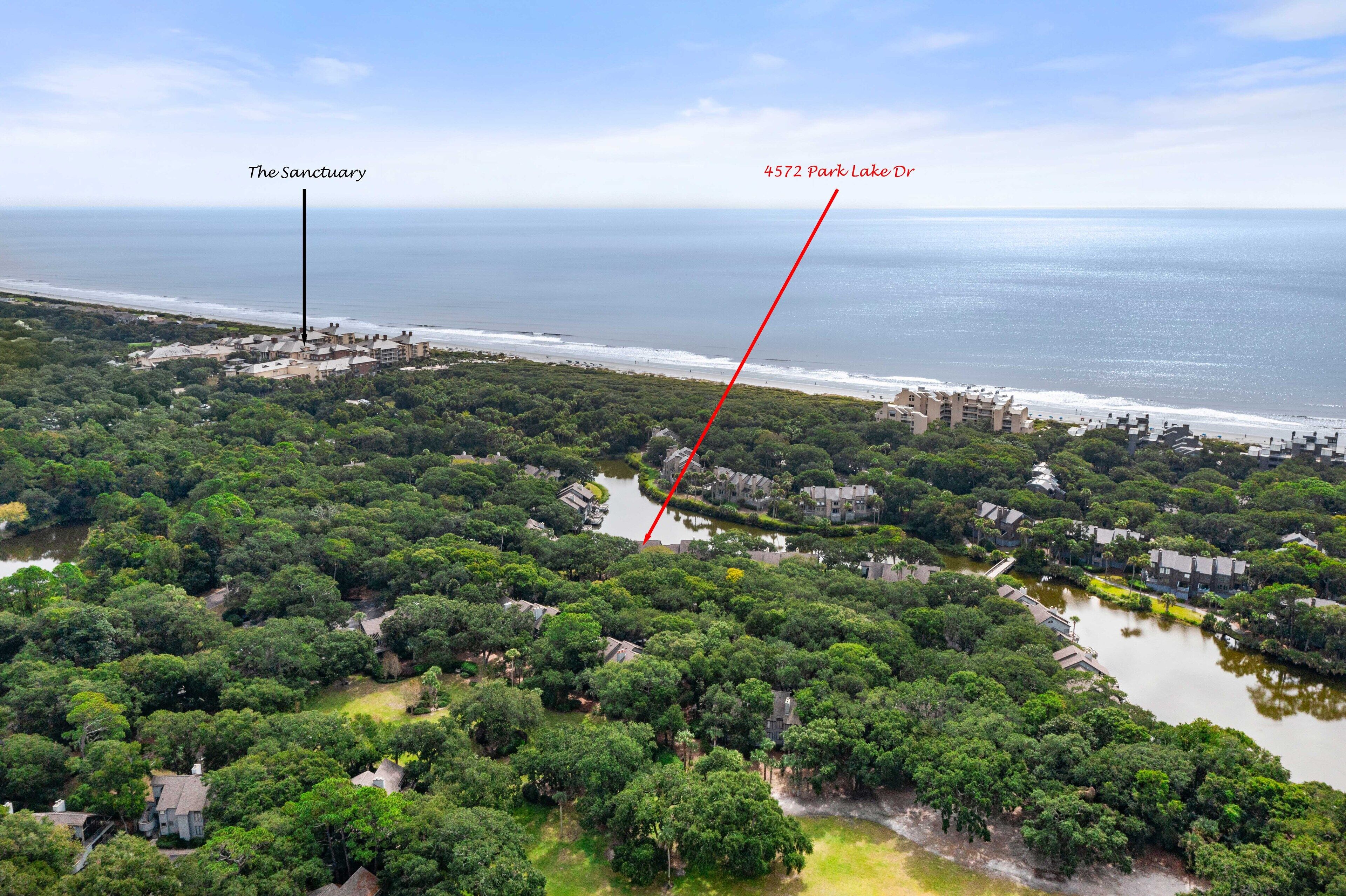 An aerial view of a coastal area with a park, labeled "The Sanctuary," and a lake labeled "4572 Park Lake."