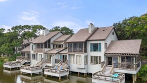 A waterfront property with multiple houses connected by walkways over water.