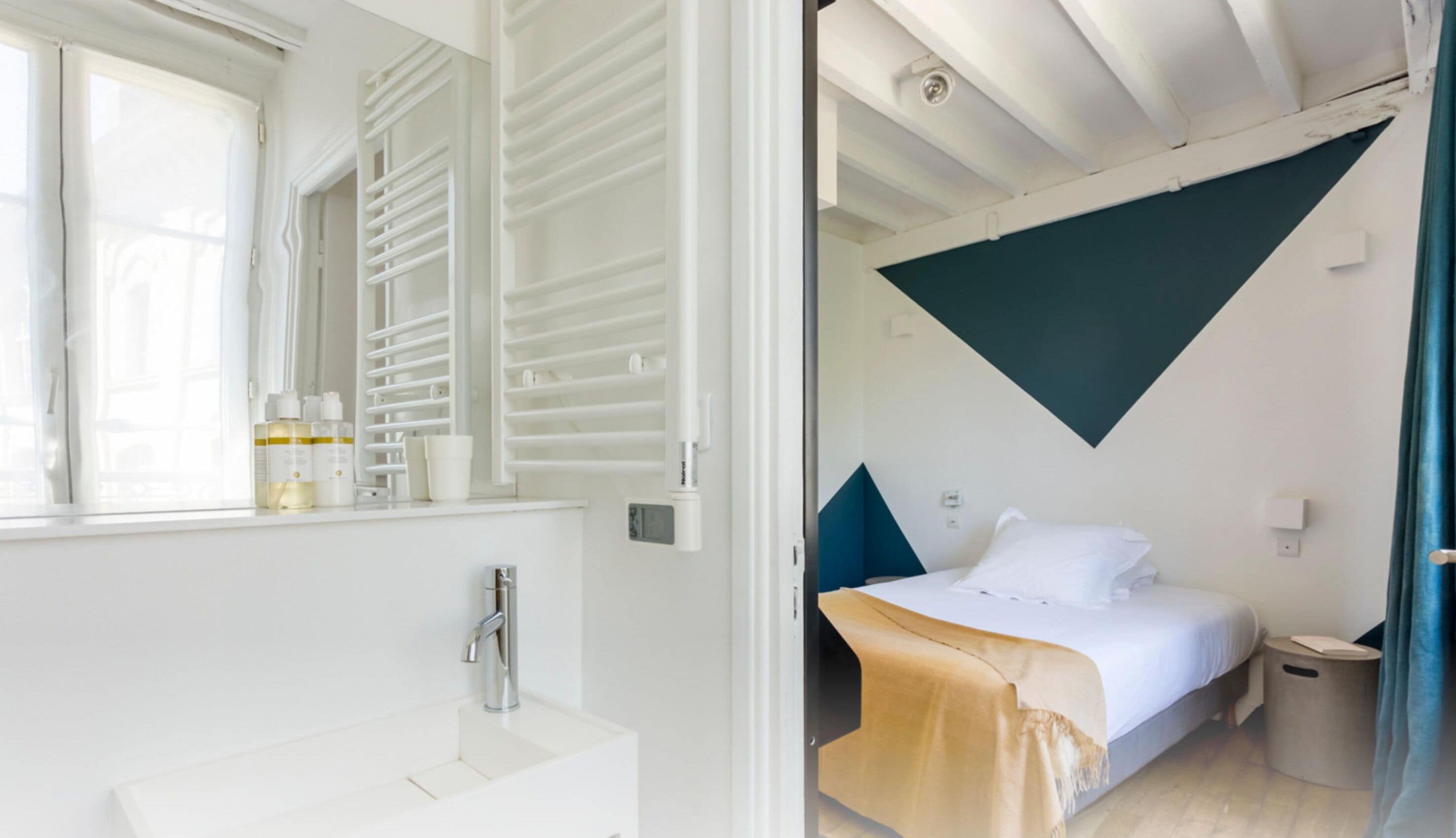 A modern bathroom with a white sink and a large mirror.