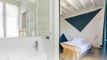 A modern bathroom with a white sink and a large mirror.