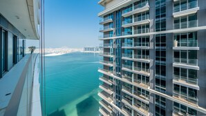 A high-rise building with multiple balconies overlooking a body of water. - Tanin - Exquisite 1BR Apartment with Sea View  (Dubai)