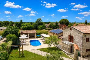 A stone building with a swimming pool, outdoor seating, and a garden. - Villa Stauri (Istria - Žminj) (Žminj)