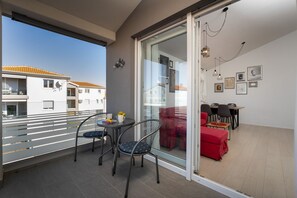 Enjoy a meal for two on the balcony with a view of the surrounding neighborhood.