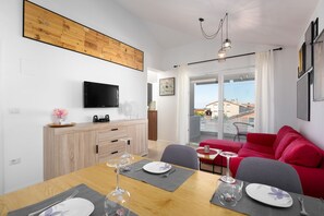 Relax in this stylish living space with a flat-screen TV, wine cooler, and city views from the balcony.
