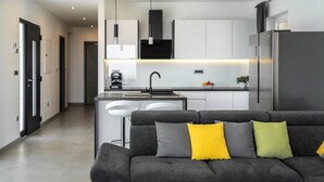 A modern kitchen with a central island, stainless steel appliances, and a minimalist design. - Villa HillSea (Kvarner - Mošćenička Draga) (Mošćenička Draga)