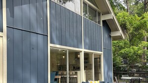Une maison moderne dotée d’une grande terrasse, d’un canapé d’angle et d’un coin repas.