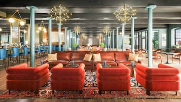 A spacious lobby with a central seating area, high ceilings, and modern lighting fixtures.