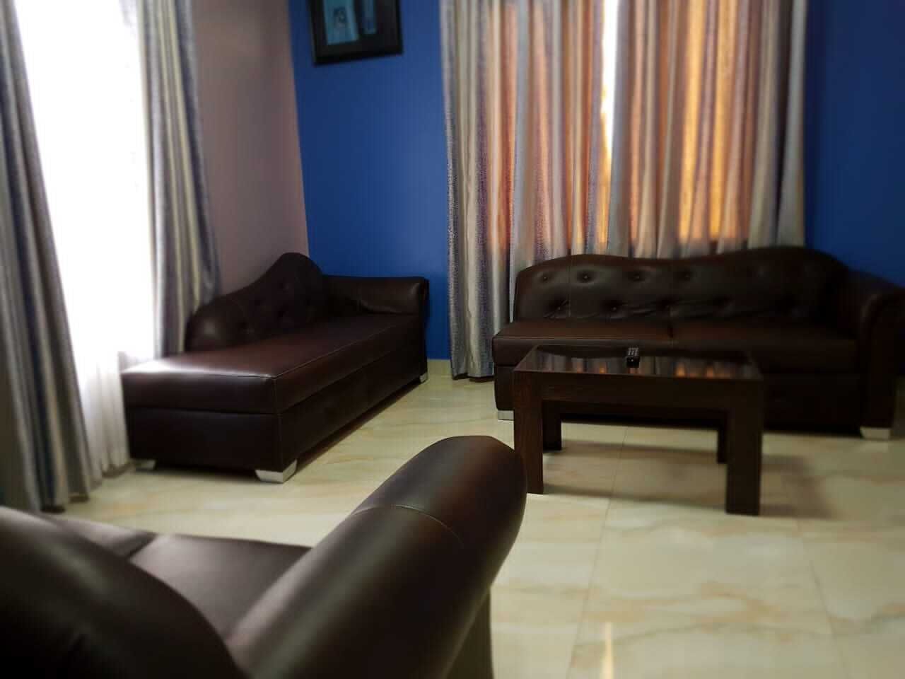 A living room with a sofa, a coffee table, and a chair.