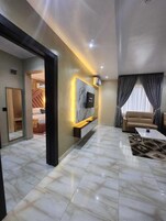 Deluxe Suite, 1 King Bed, Refrigerator | Living area | 32-inch Smart TV with satellite channels