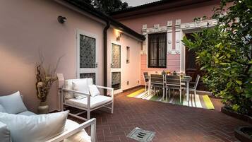 Relax in this inviting patio area with a brick floor, dining table, and comfortable seating.