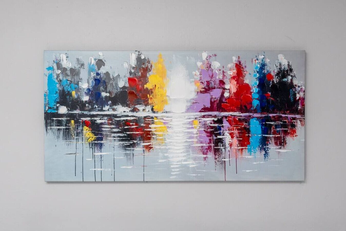 A large abstract painting with a reflective surface.