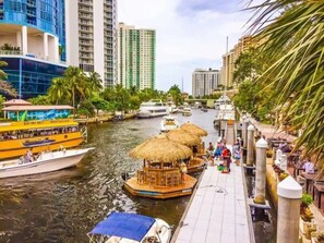 A waterfront area with boats, a dock, and buildings in the background. - The Residences @ Lake Ridge #3 (Fort Lauderdale)