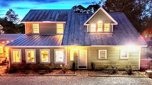 A two-story house with a gabled roof and a front porch.