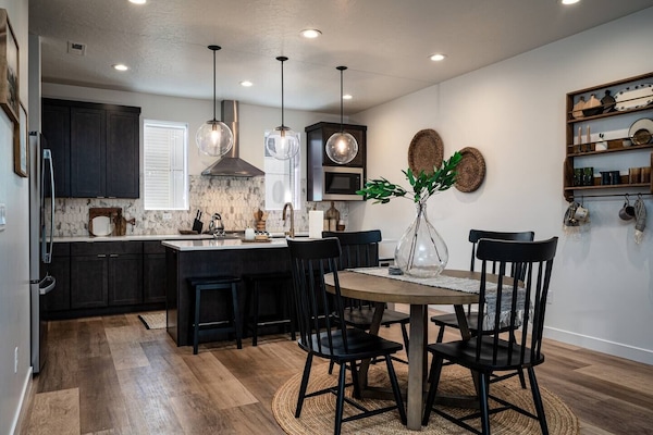 The open-concept living space, complete with a dining area, facilitates effortless conversation with family and friends.