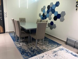 Enjoy meals in this stylish dining area with a glass table and comfortable seating for four.