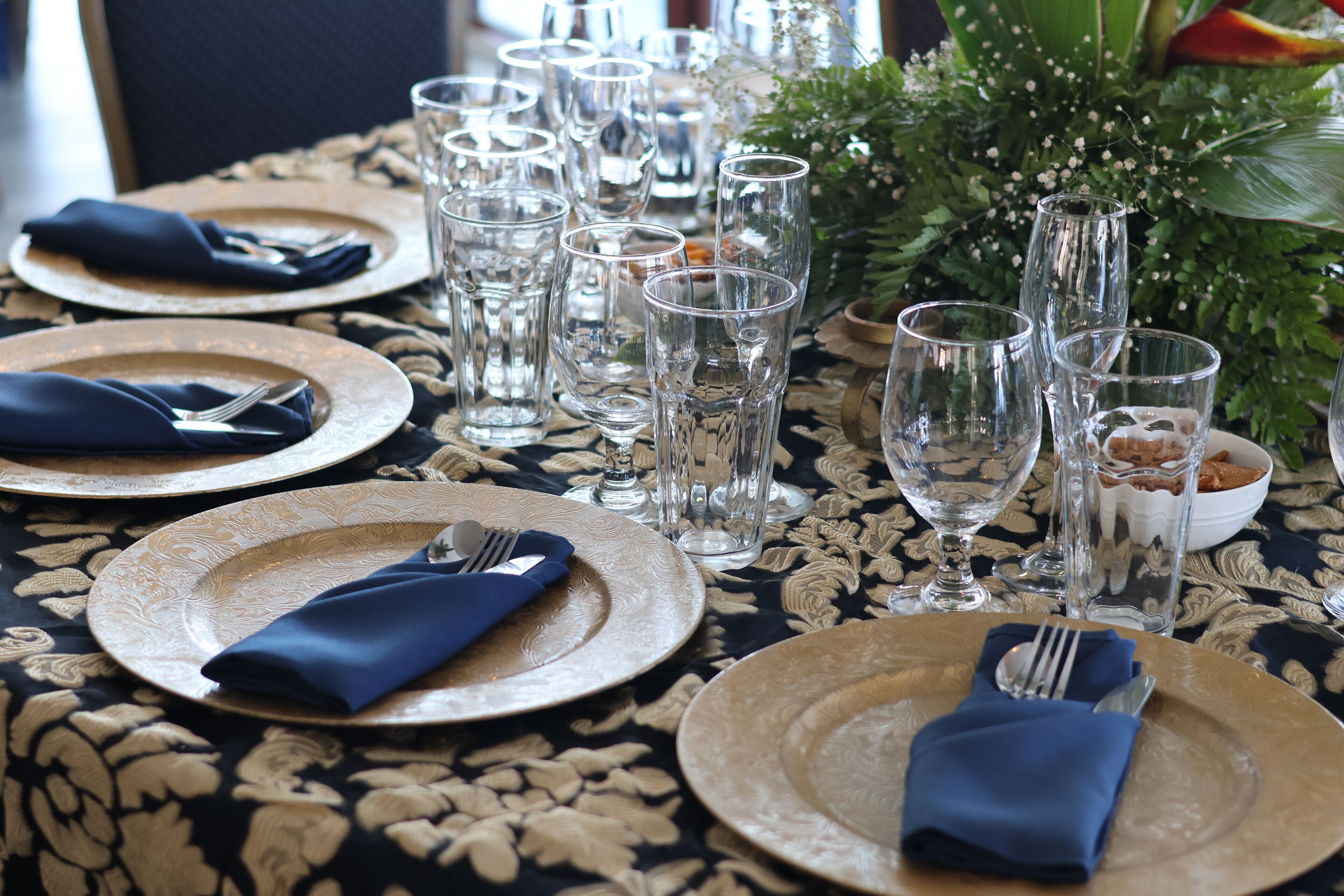 A table set for a meal with plates, cutlery, and glasses.