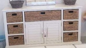 A bedroom with a bed, a white dresser with woven baskets, and a framed picture on the dresser. - Hervana's Casa Blanca (St. Thomas)