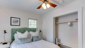 A bedroom with a bed, a ceiling fan, a window, a nightstand, and a wardrobe. - Peaceful Spacious 1BR w Sunroom! - mins to metro (Alexandria)