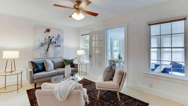 A modern living room with a grey sofa, a beige armchair, a coffee table, and a ceiling fan. - Peaceful Spacious 1BR w Sunroom! - mins to metro (Alexandria)